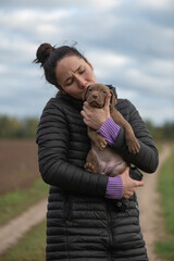 Beautiful young girl with a dog outdoors.