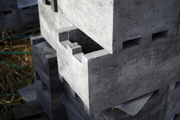 Large concrete blocks for the fence. They are dark in color.