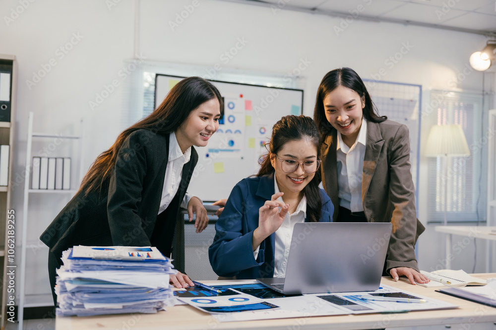 Poster three asian businesswomen are collaborating on a project, analyzing charts and data on a laptop, wor