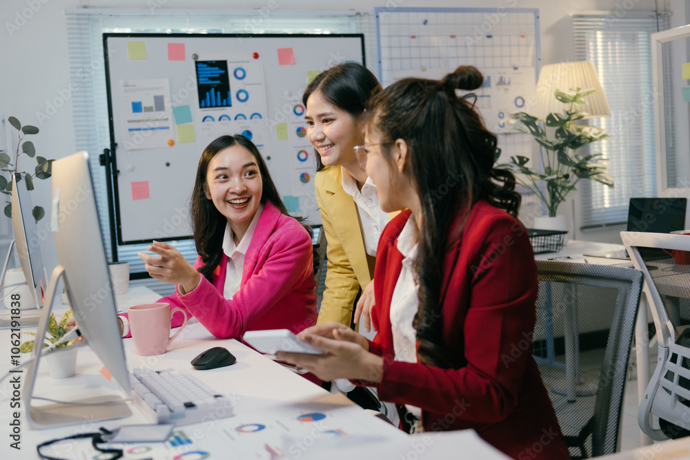 Poster three asian businesswomen are working together on a computer, discussing and analyzing financial dat