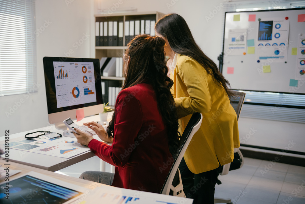 Poster two businesswomen collaborating on a project, analyzing financial charts on a computer, surrounded b