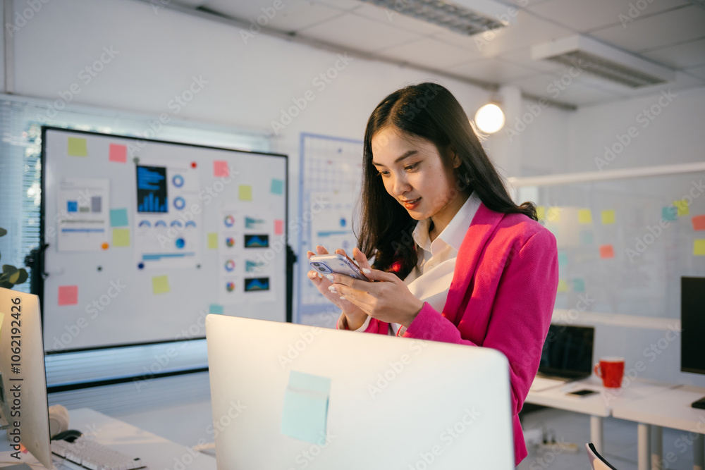 Poster young asian businesswoman wearing pink jacket using smartphone in modern office with whiteboard with