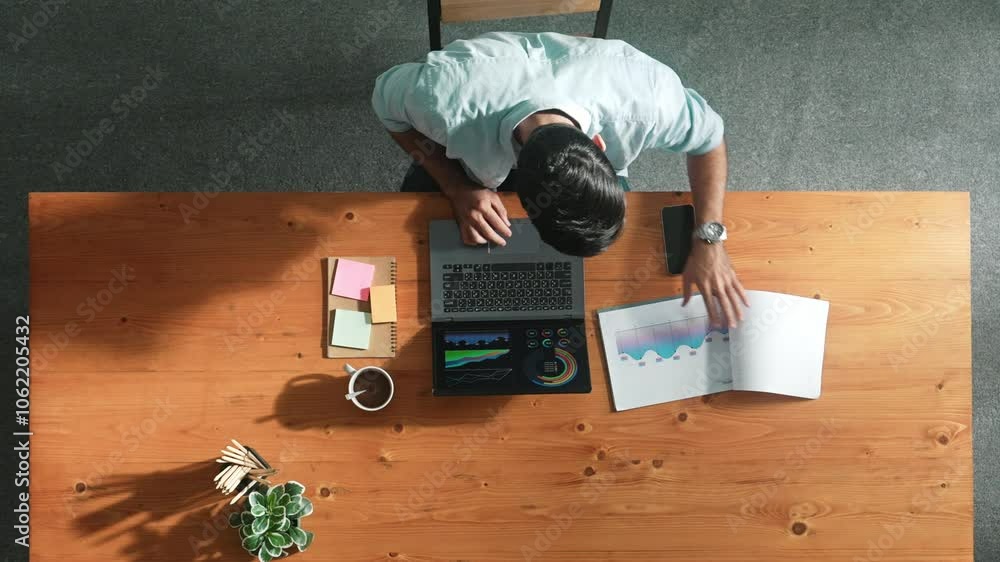 Poster top aerial view of manager working on laptop while looking at data analysis. leader compare financia