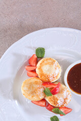 Cottage cheese pancakes, cheesecakes, pancakes with strawberries and jam. Healthy and dietary breakfast.