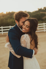 Fototapeta premium Couple kissing on their wedding day on their ranch.