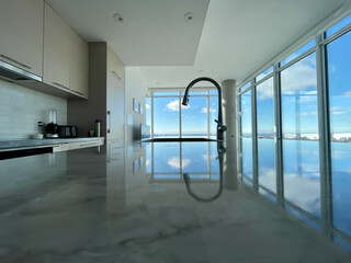 A spacious kitchen that has numerous windows and a large sink