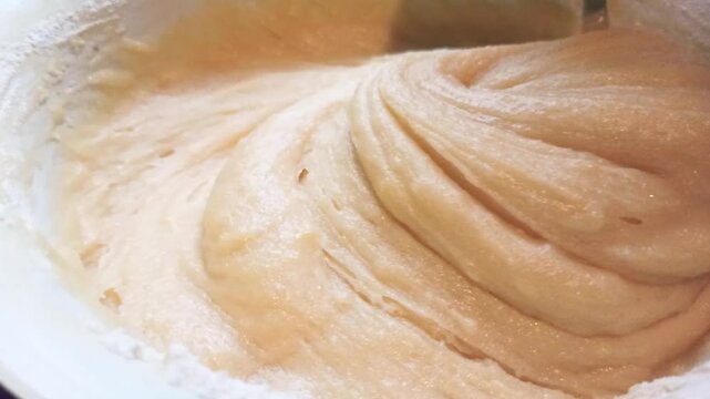 Proccess of making shortbread dough for a pie, mixing with spoon. Horizontal 4k footage. Baking