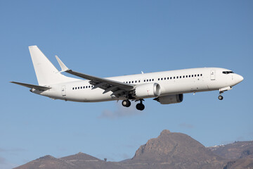 Fototapeta premium White modern airliner landing at airport.