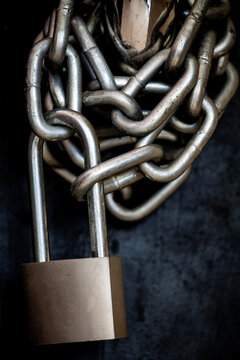 Close-up of a metal Chain locked with a padlock on a door