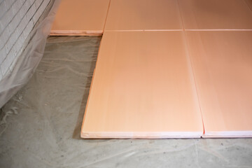 Laying polystyrene foam on the floor. Thermal insulation of the floor surface in the house with...