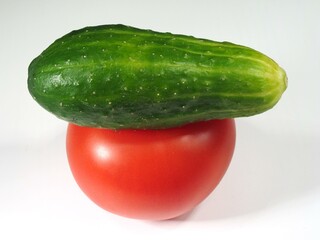 Fresh Cucumber and Tomato Stacked on White Background