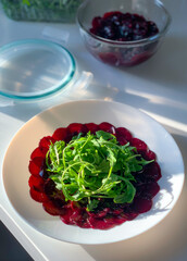 This vibrant Beetroot Salad with greens, berries, and dressing is perfect as an appetizer