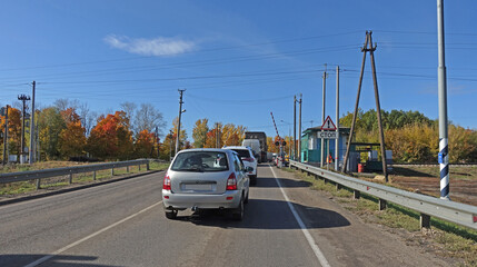 Cars passing a railway crossing
