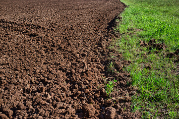 Plowed land, divided from unplowed land