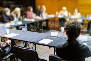 A group meets around a table for a collaborative discussion during an event in a community center...