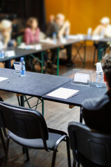 Participants engage in a discussion at a roundtable meeting in a collaborative workspace during the...