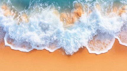 Aerial view of ocean waves crashing on a sandy beach, showcasing the turquoise water, white foamy waves, and warm golden sand.  This image evokes tranquility, relaxation, and summer vibes.