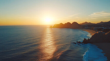 golden sunset over ocean and rocky coastline in mexico