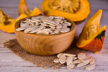 Pumpkin seeds in a wooden bowl.Close-up.