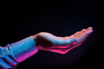 Two hands showing a sale advertisement copy space and black background with burst of colors with colorful glitter style