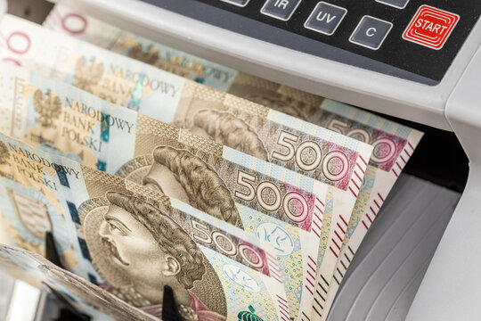 Poland money. Polish banknotes of 500 zlotys in a cash counting machine. Business and finance concept, exchange rate, financial calculations, close up