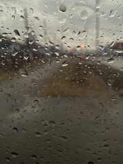 Rainy weather. Car window against the background of rain. Rainy weather aesthetics.
