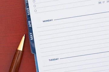 Empty day planner with Monday with pen on desk