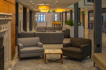 Hall living in a building with lamps on the ceiling.