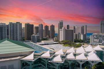 The Hawaii Convention Center with skyscrapers, hotels and luxury condos, lush green trees, ocean...