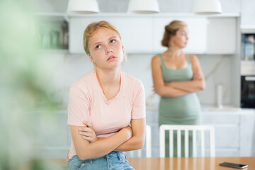Displeased disappointed teenage girl not talking to mother after discord. Concept of disagreement...