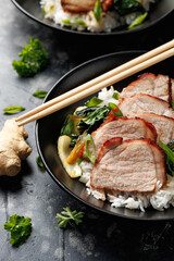 Chinese BBQ Pork Char Siu with rice and bok choy in a black bowl