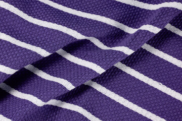 Close-up of textured purple fabric with white stripes, perfect for textile backgrounds, fashion design, and interior decor projects.