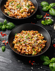 Homemade Taco Beef Pasta in a black bowl. Mexican food.