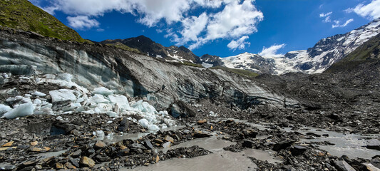 Melting of a mountain glacier and large blocks of snow on the Alibek glacier in Dombai, in the Karachay-Cherkess Republic, Russia.