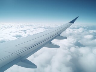 A sleek airplane wing soaring above a sea of fluffy clouds under a clear blue sky, evoking a sense of adventure and freedom.