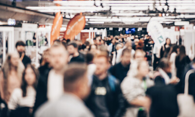 Abstract blurred people at exhibition hall of expo event trade show. Business convention show or...