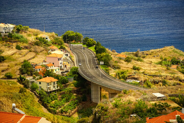 An expressway running along the ocean in a picturesque area among the buildings