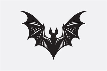 A black silhouette of a flying bat with outstretched wings.