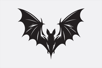 A black silhouette of a flying bat with outstretched wings.