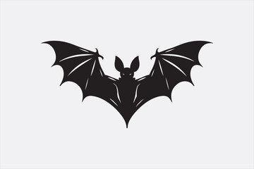 A black silhouette of a flying bat with outstretched wings.