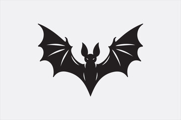 A black silhouette of a flying bat with outstretched wings.