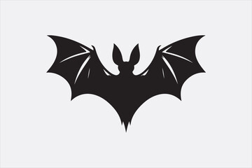 A black silhouette of a flying bat with outstretched wings.