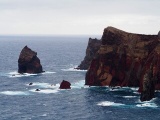 From a high vantage point, see eroded cliffs jutting into the ocean below, capturing the raw and ancient beauty of a pristine, - Vereda da Ponta de Sao Lourenco, Madeira, Portugal.