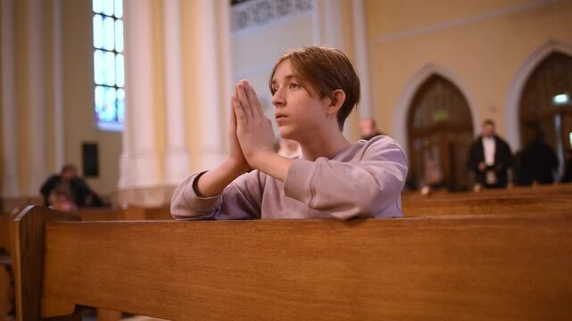  Catholic boy is praying to god in temple