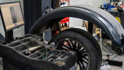Fototapeta premium Wheel being balanced in a car workshop. 