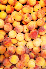 Background orange red peach. Ripe juicy peaches on the counter at the grocery market, top view