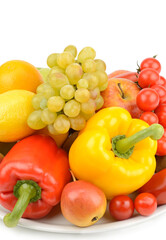 Healthy vegetables and fruit on a plate isolated on white. There is free space for text.