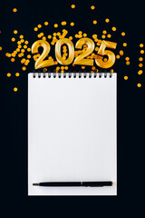 Happy New year and Christmas holiday concept 2025 with empty notebook and pen on black background