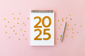 2025 New Year concept with notebook and pen. Flat lay style. Christmas planning concept