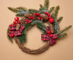 Round Christmas wreath on brown background